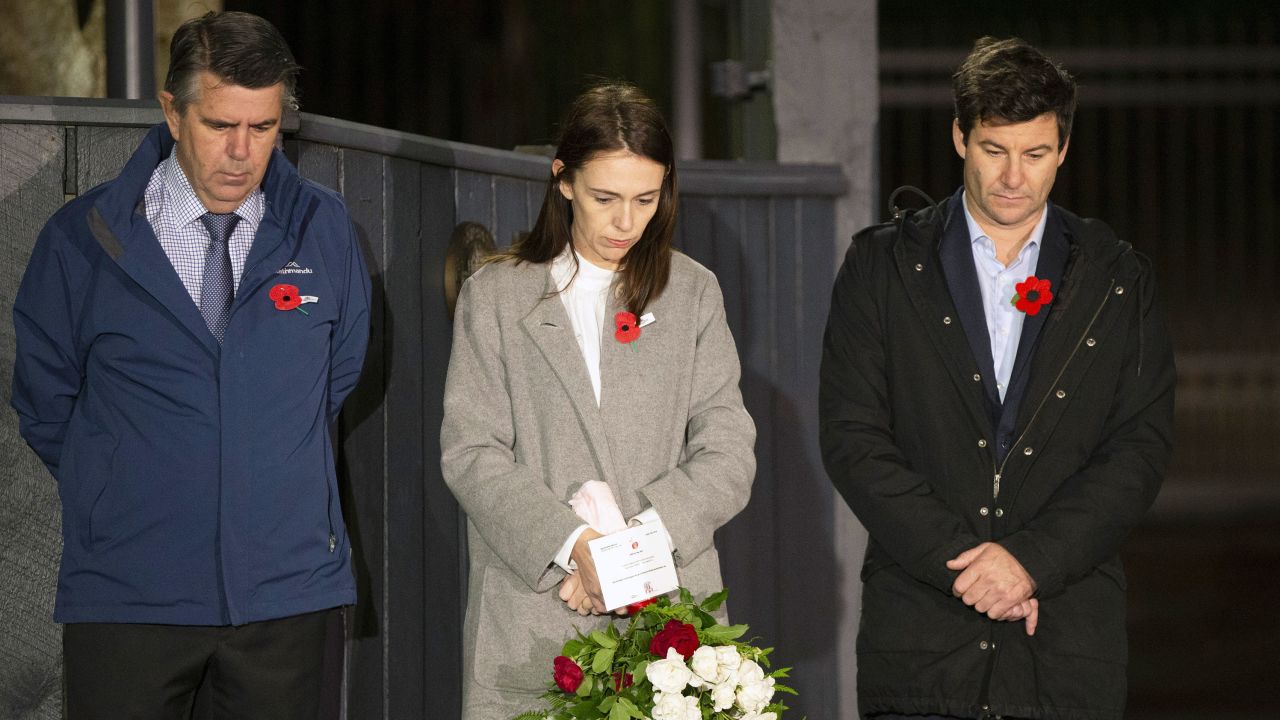 New Zealand Prime Minister Jacinda Ardern stands at dawn on the driveway of Premier House with her father Ross Ardern, left, and partner Clarke Gayford to commemorate Anzac Day in Wellington, New Zealand, on April 25, 2020. 