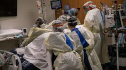 A "prone team," wearing personal protective equipment (PPE), turns a COVID-19 patient onto his stomach in a Stamford Hospital intensive care unit (ICU), on April 24, 2020 in Stamford, Connecticut. The civilian/military team, made up of physical and occupational therapists turns over COVID-19 patients to help their labored breathing and increase lung capacity. Stamford Hospital, like many across the US, opened additional ICUs and have been augmented by military medical personnel to deal with the heavy patient load. Stamford, with it's close proximity to New York City, has the highest number of coronavirus patients in Connecticut.