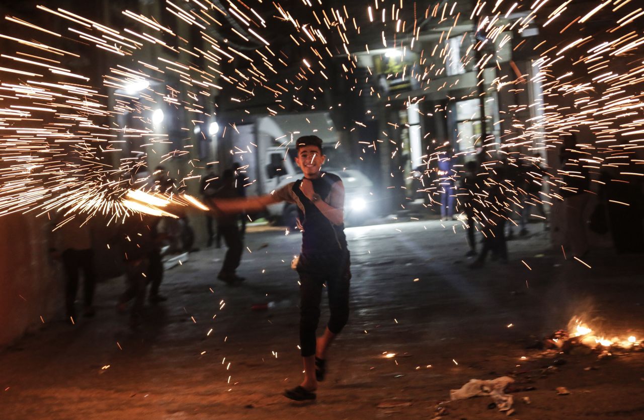 A youth in northern Gaza swings a homemade sparkler while celebrating Ramadan on April 26.