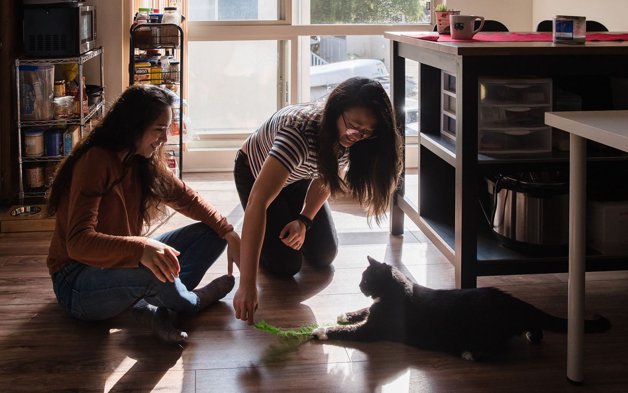 Morgan Miller (left) and Sarah Chan (right) play with Silvia, age 6, in their apartment in San Diego's Pacific Beach neighborhood. 