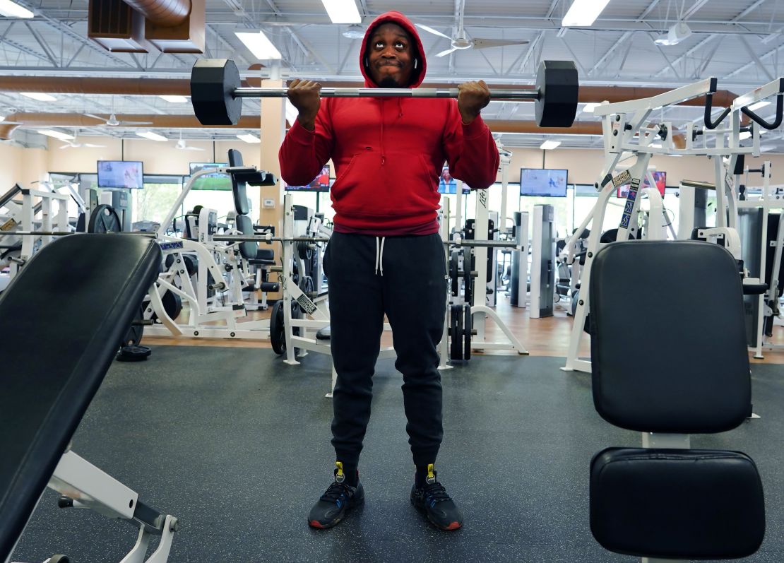 A man, one of two people at a gym, lifts weight in Lilburn, Georgia on April 24.