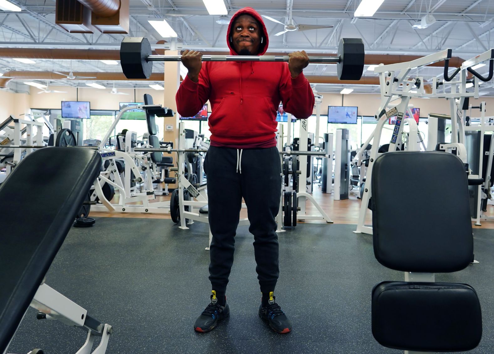 A gym patron lifts weight at Fitness 19 in Lilburn, Georgia, on April 24. Georgia is allowing gyms to reopen with some <a  target="_blank">guidelines for social distancing.</a>