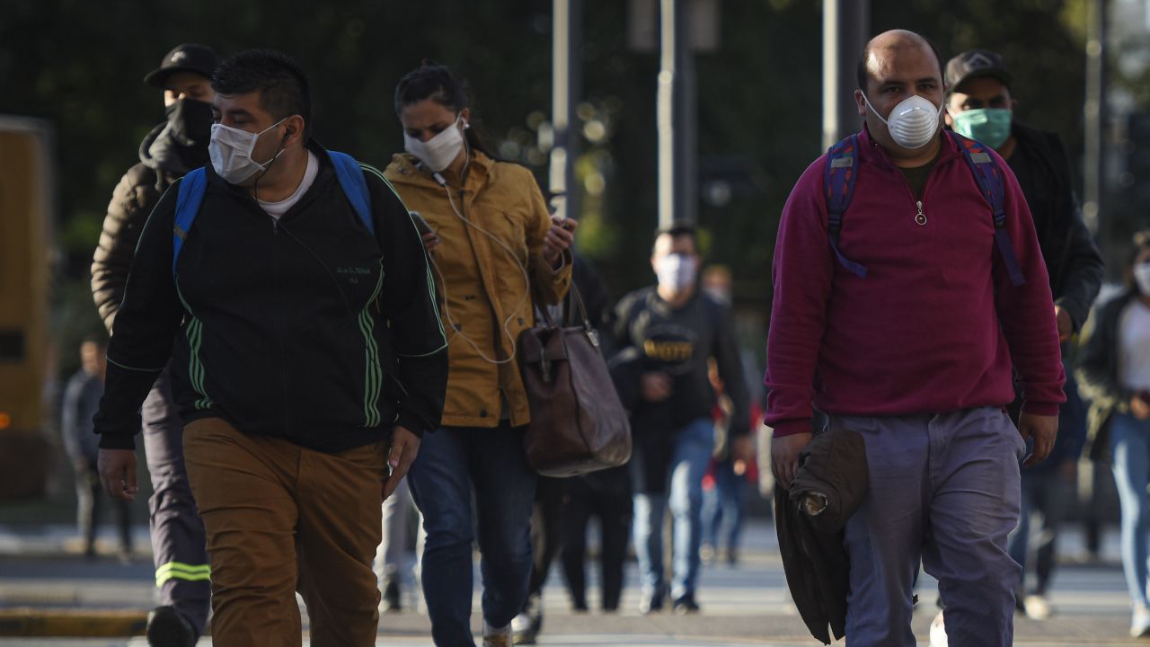 BUENOS AIRES, ARGENTINA - APRIL 14: Pedestrians wearing face masks cross the Brazil street in Constitution neighborhood on April 14, 2020 in Buenos Aires, Argentina. Since tomorrow, it will be obligatory to wear face masks in the streets and stores in Buenos Aires City. Nationwide State-ordered isolation was extended until April 26 and some provinces ordered the use of face masks. Meanwhile, measures are being analyzed to alleviate the economic impact of the pandemic.  (Photo by Marcelo Endelli/Getty Images)