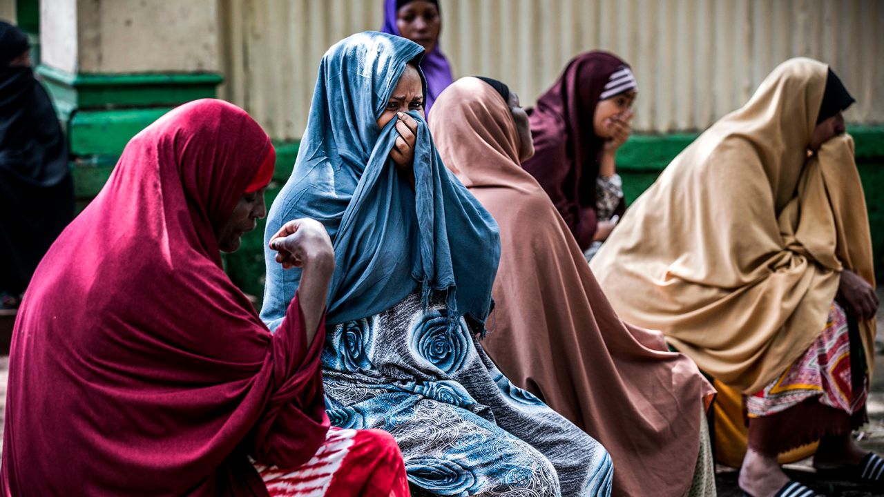 Yassin Hussein Moyo's relatives cry during his burial on March 31, 2020.