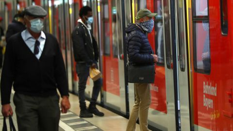 People wear masks at the central station in Munich, Germany, on Monday.