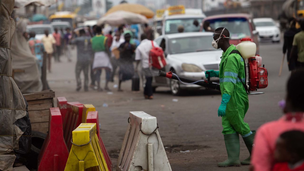 A city worker disinfects a market in Accra, Ghana in March, as the virus begins to spread around the world.