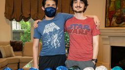 Brothers Matthew and Jeremy Jason prepare to turn hundreds of kippahs into face masks. These donated head coverings came from a drop box at Congregation Brith Shalom in Houston. 