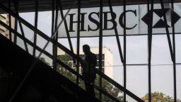 The silhouette of a person riding on an escalator is seen at the HSBC Holdings Plc headquarters building in the Central district of Hong Kong, China, on Monday, April 27, 2020.