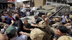 Anti-government protesters scuffle with Lebanese army soldiers in the town of Zouk Mosbeh, north of Beirut, Lebanon, Monday, April 27, 2020. Bilal Hussein/AP