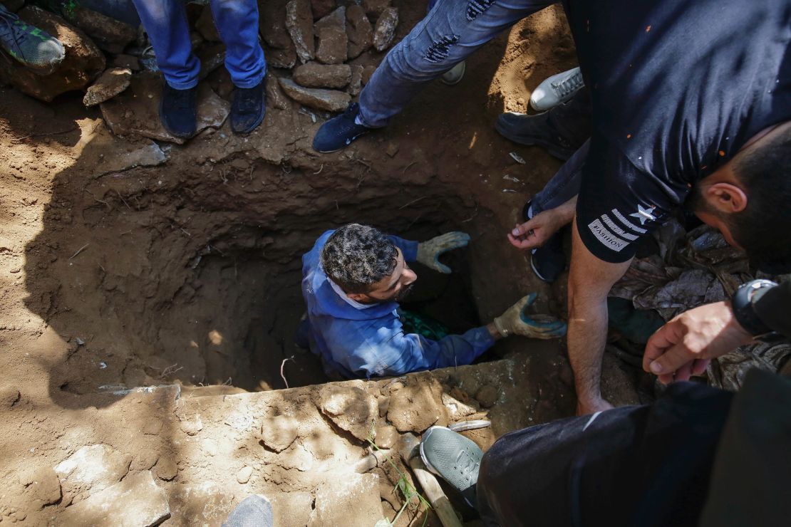 Mourners prepare to bury the body of protester Fawaz al-Samman, who died of a gunshot wound sustained during clashes in Tripoli.