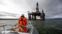 An employee stands on the deck of a pilot boat in view of the Ocean Princess oil platform, operated by Diamond Offshore Drilling Inc., in the Port of Cromarty Firth in Cromarty, U.K., on Tuesday, Feb. 16, 2016. The pace of drilling in the North Sea, the center of U.K. oil production for the past 40 years, has sunk to a record as crashing energy prices force explorers to abandon costly projects. Photographer: Matthew Lloyd/Bloomberg via Getty Images