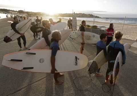 Surfers in Sydney wait for officials to open Bondi Beach on April 28 as restrictions were eased. The beach was open to swimmers and surfers, but only for exercise.
