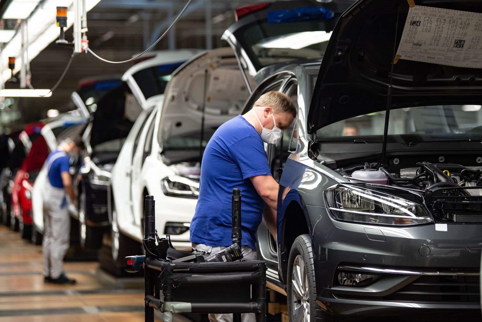 An employee works on the production line at a <a href="https://www.trupilariante.com/2020/04/27/business/volkswagen-restart-production-wolfsburg/index.html" target="_blank">reopened Volkswagen plant</a> in Wolfsburg, Germany, on April 27. The world's largest carmaker has made 100 changes to the way its plants operate as it tries to restart business without risking the health of hundreds of thousands of workers.