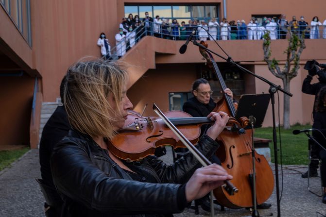 Medical workers in Athens, Greece, watch as the Hellenic Broadcasting Corporation orchestra performs in the yard of the Attikon University Hospital on April 23.