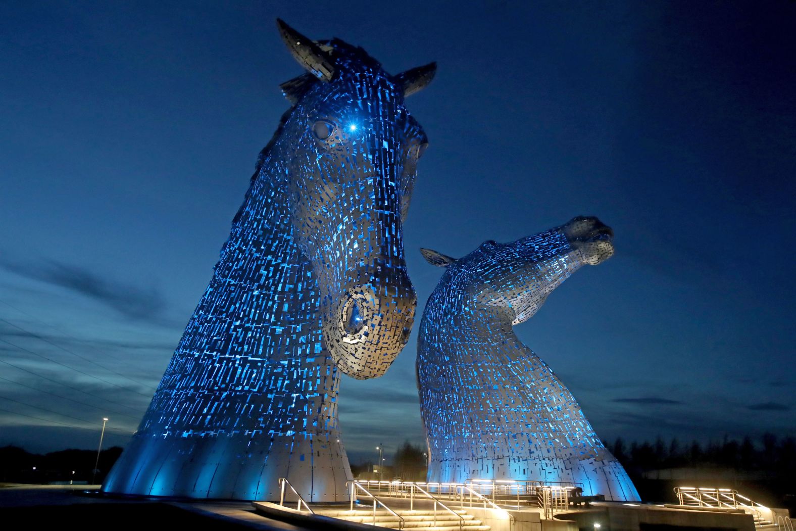 The Kelpies sculpture in Falkirk, Scotland, is illuminated by blue light as a tribute to the United Kingdom's National Health Service and social-care workers on April 7.