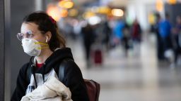 SEATTLE,  WA - MARCH 15:  A passenger wearing a mask prepares to board a flight departing the Seattle-Tacoma International Airport on March 15, 2020 in Seattle, Washington. The state of Washington has over 600 confirmed cases of coronavirus (COVID-19) and U.S. airports have been crushed with returning citizens after restrictions on travel from Europe were implemented. (Photo by John Moore/Getty Images)