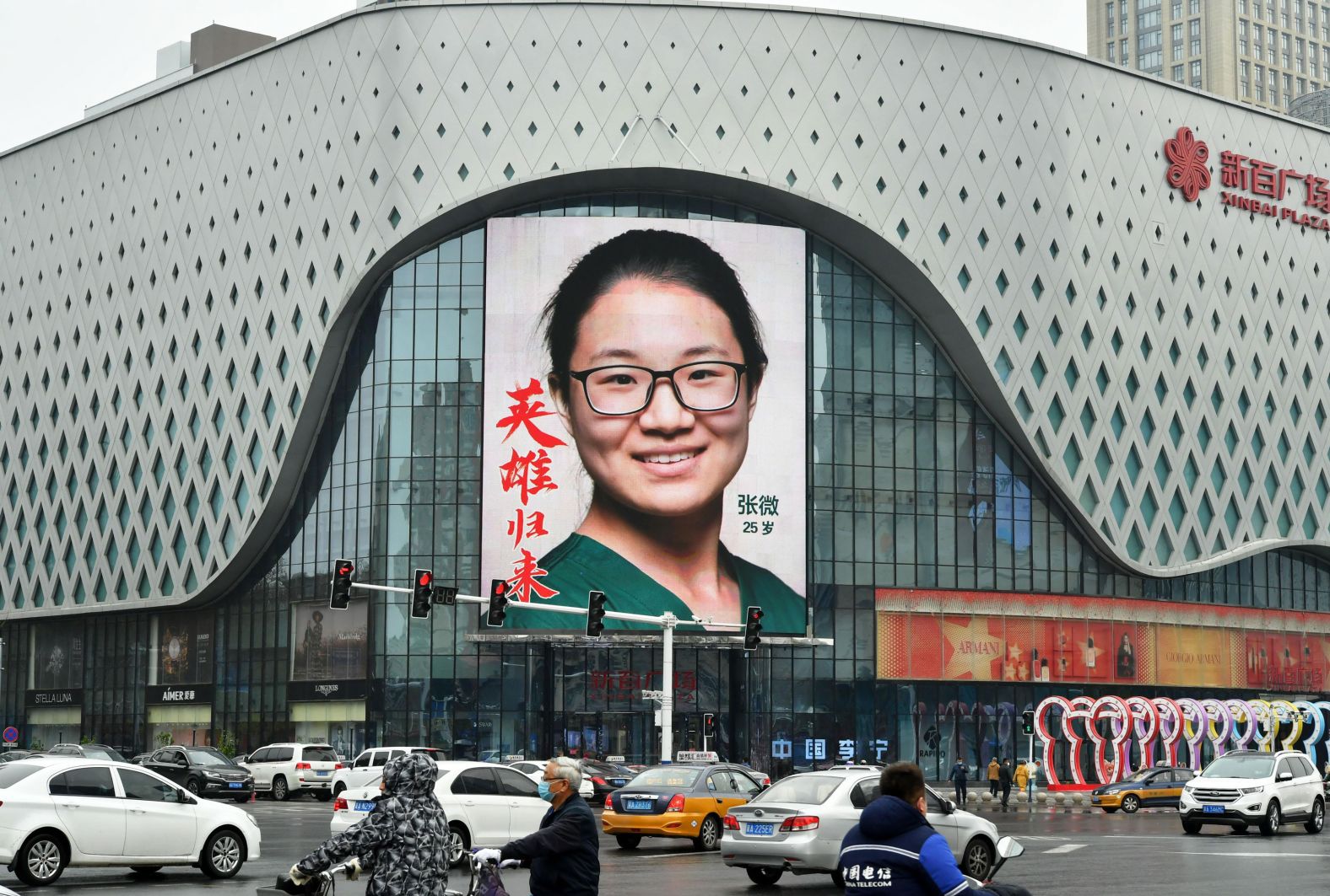 A photo of a medical worker is seen on an outdoor screen in Shijiazhuang, China, on April 1. Medical workers were displayed at the city center to pay tribute to those fighting on the front lines of the pandemic.