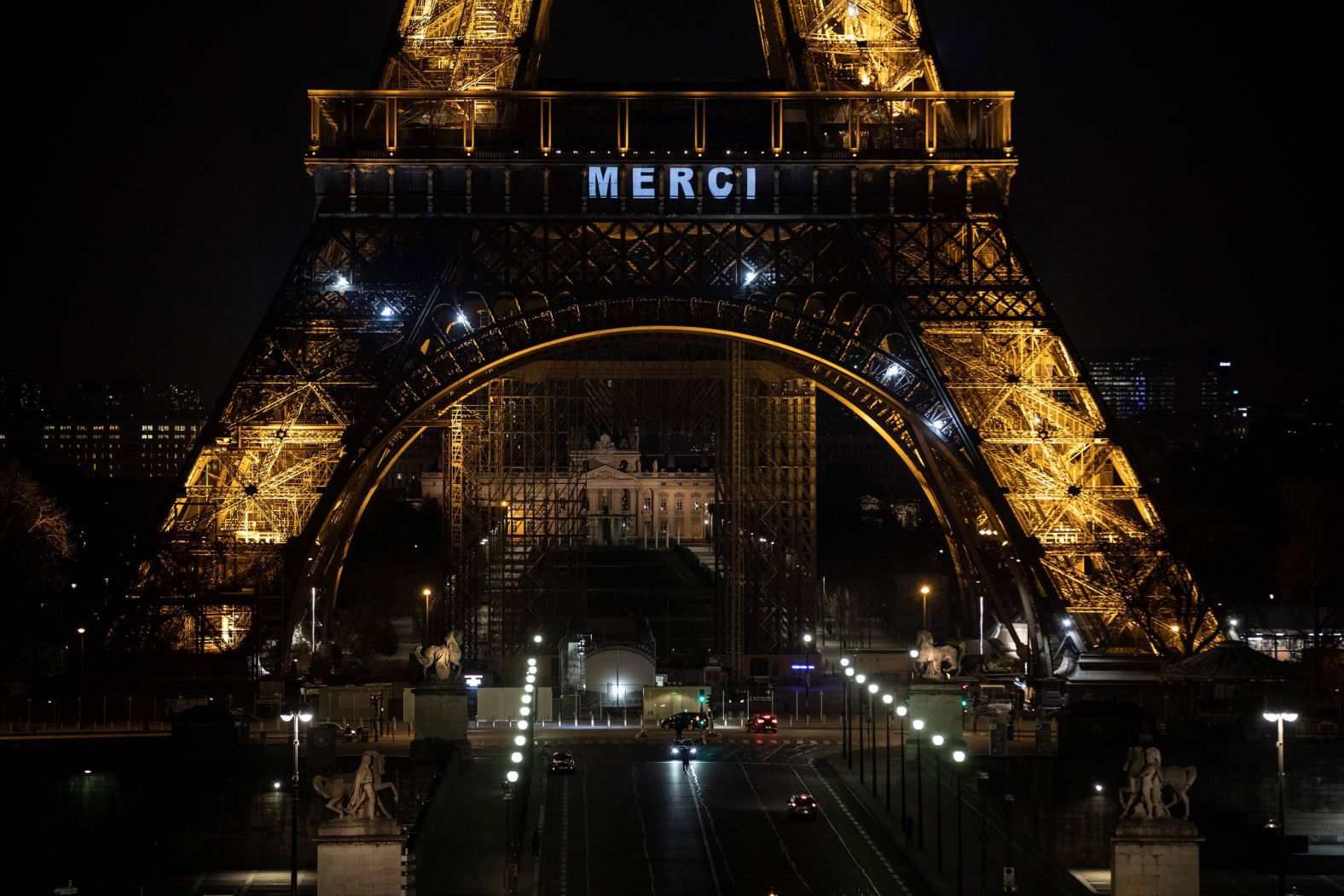 The word "merci" (thank you) is displayed on the Eiffel Tower in Paris as a tribute to essential workers on March 27.