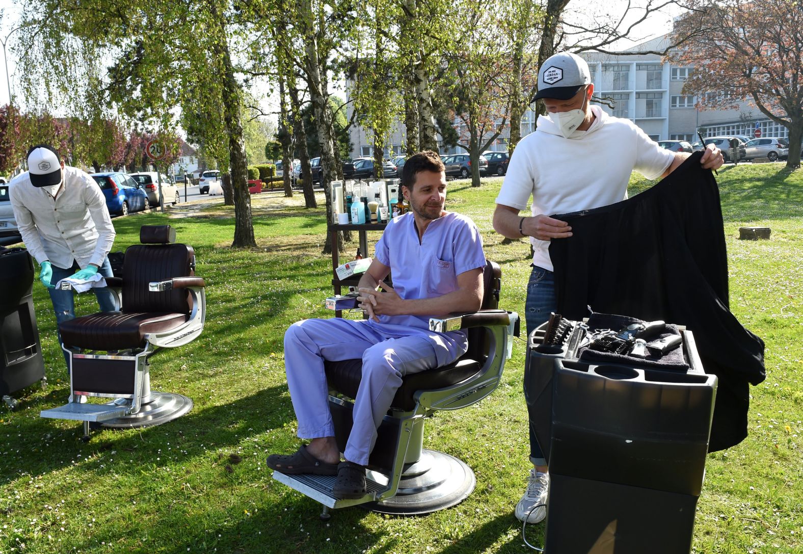Two hairdressers prepare to give free haircuts to medical workers in front of a hospital in Lens, France, on April 17.