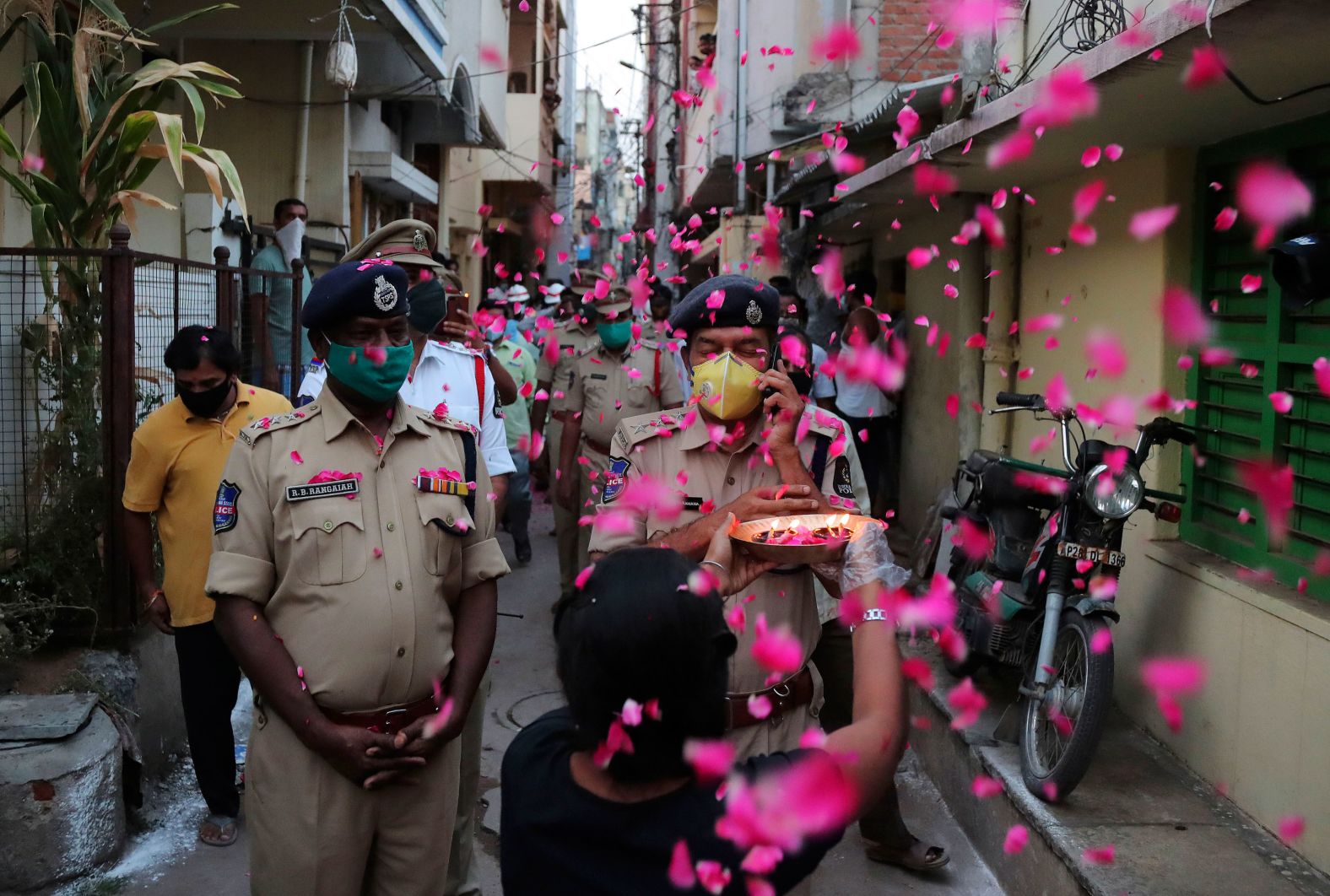Police officers are also among the front-line workers being thanked. Here, they are showered with rose petals in Hyderabad, India, on April 19.