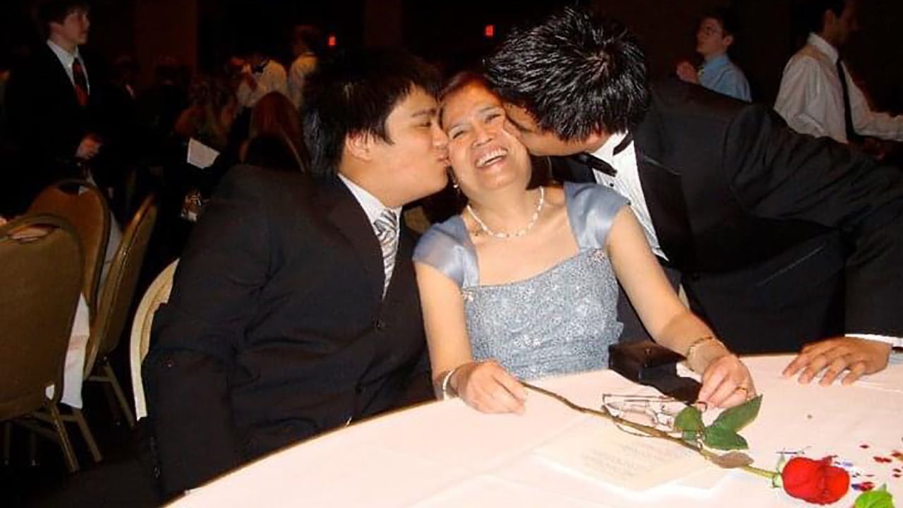 Celia Yap-Banago (center) with her two sons, Jhulan (right) and Josh. 