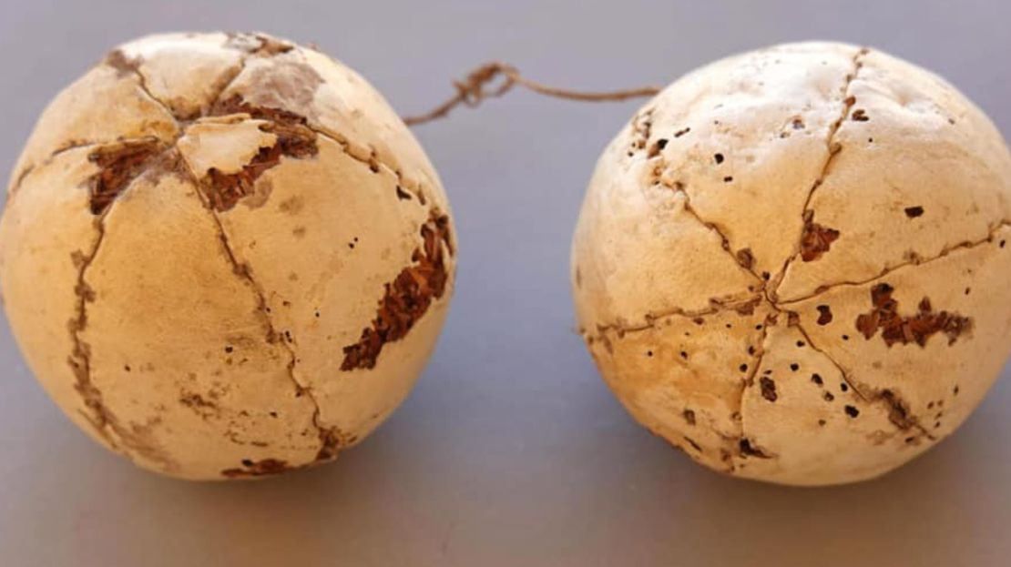 Nearby, a pair of leather balls tied together with thread were found.