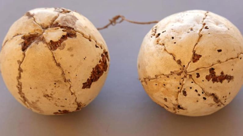 <strong>Interesting discoveries: </strong>Close<strong> </strong>by, archaeologists also unearthed red leather sandals and a pair of leather balls tied to each other with thread, pictured.