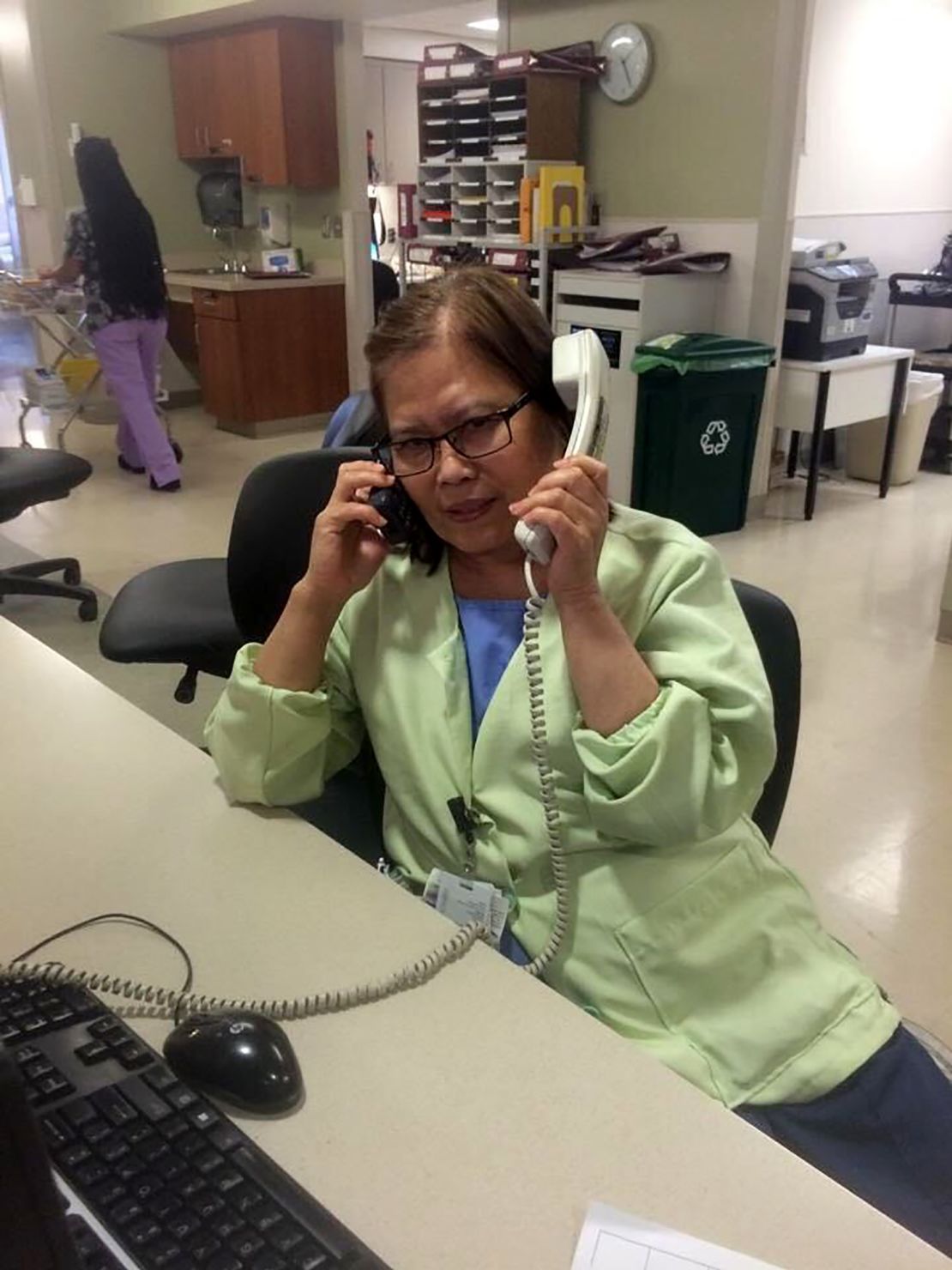 Jhulan Banago says this photo of his mom, Celia Yap-Banago, always makes him laugh. "I think it encompasses mom -- hardworking and joking. No one answers two phones and has two conversations at once. ... It's nice to see that mom was so happy at work."