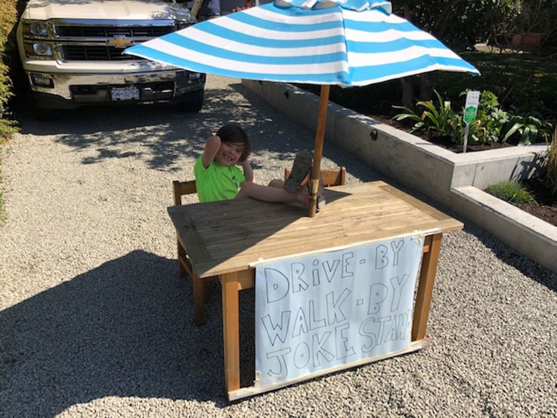 Callaghan McLaughling sits at his joke stand and waits for people to walk or drive by.