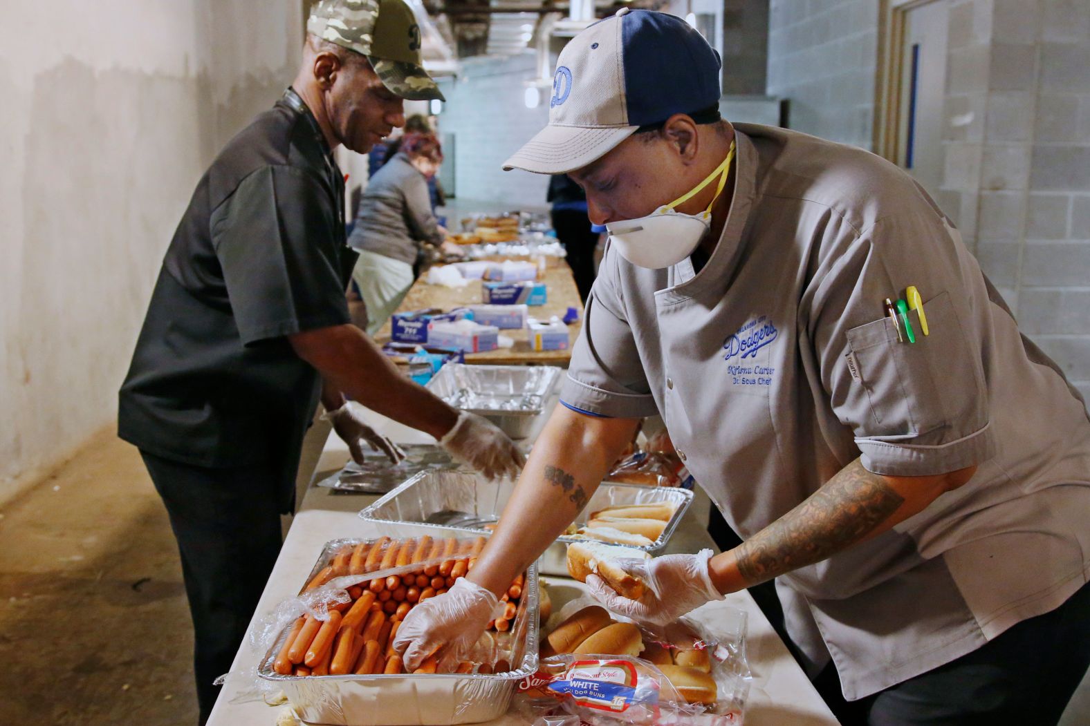 Krisna Carter, a junior sous-chef for the Oklahoma City Dodgers, prepares hot dogs for front-line workers on what would have been the minor-league baseball team's opening day on April 9.