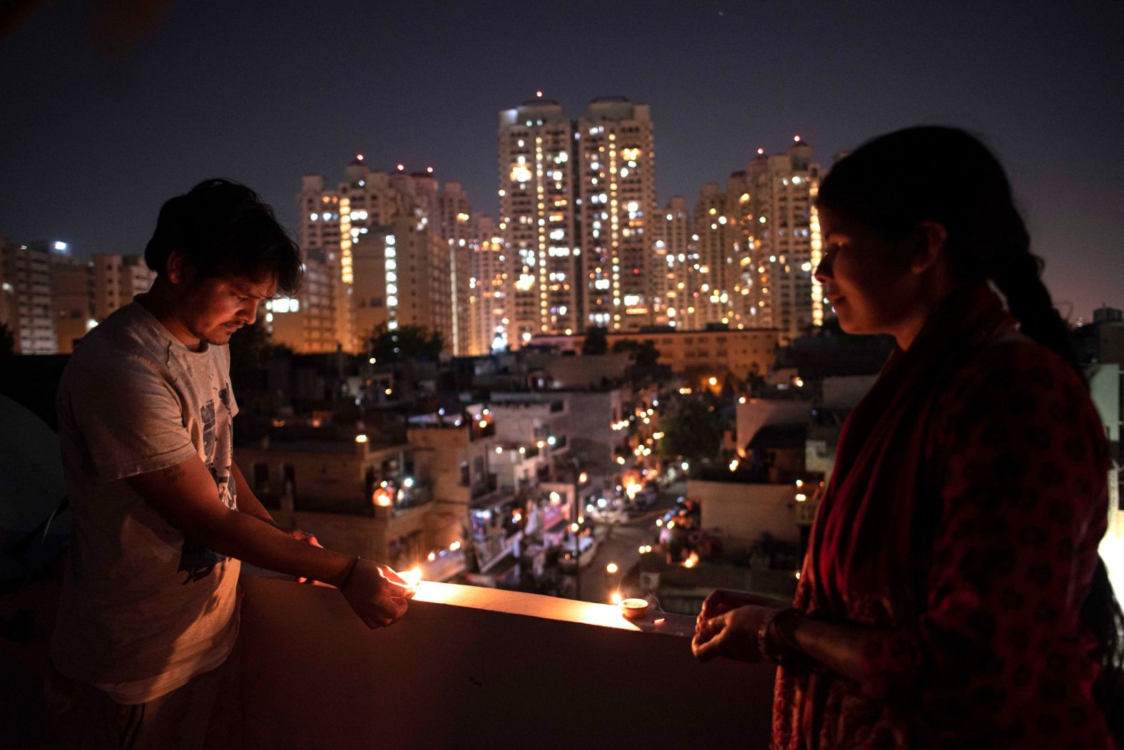 People in New Delhi light oil lamps on April 5 to show their support for those working on the front lines of the crisis.