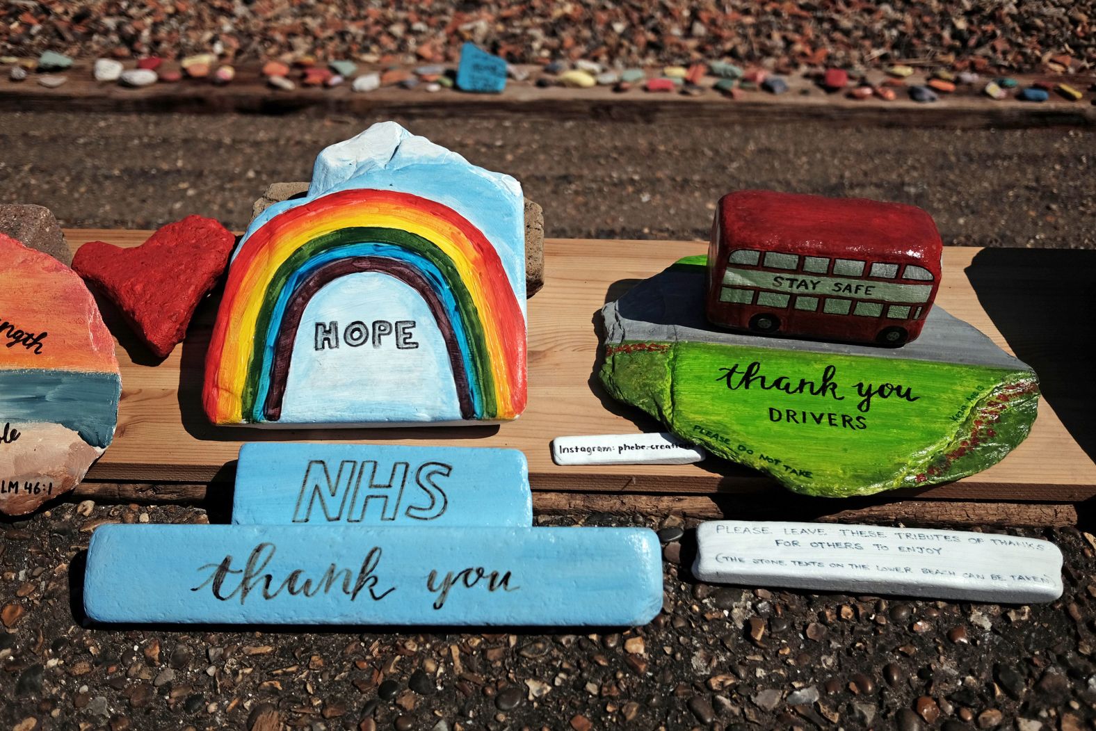 Tributes to health-care workers and bus drivers are on display at the Folly House Beach in London on April 26.