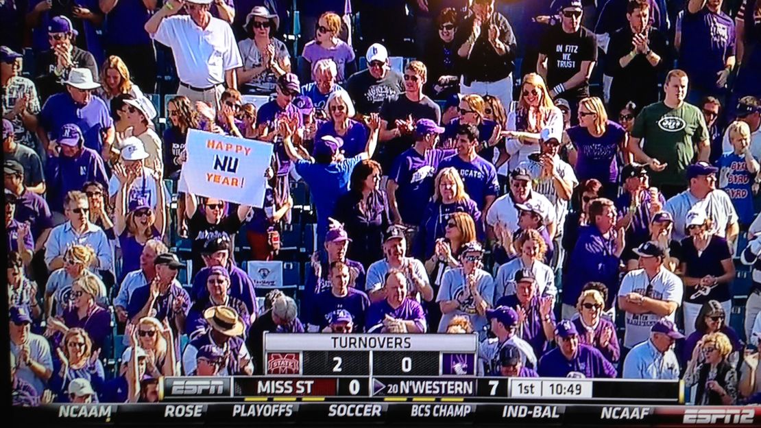 The sign-holding author appeared on ESPN2 during the 2013 Gator Bowl in Jacksonville, FL, when Northwestern finally won their first bowl game in 64 years.