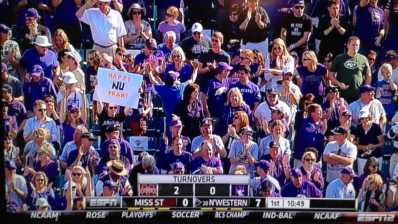 <strong>Happy NU Year</strong>: The sign-holding author appeared on ESPN2 during the 2013 Gator Bowl in Jacksonville, FL, when Northwestern finally won their first bowl game in 64 years.