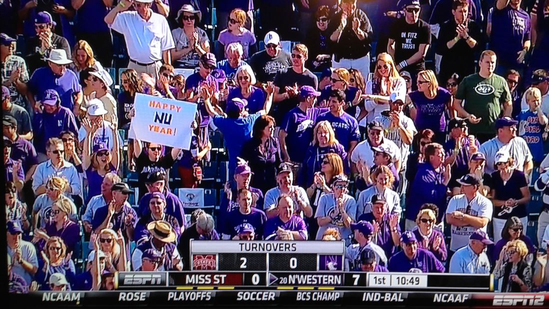 <strong>Happy NU Year</strong>: The sign-holding author appeared on ESPN2 during the 2013 Gator Bowl in Jacksonville, FL, when Northwestern finally won their first bowl game in 64 years.