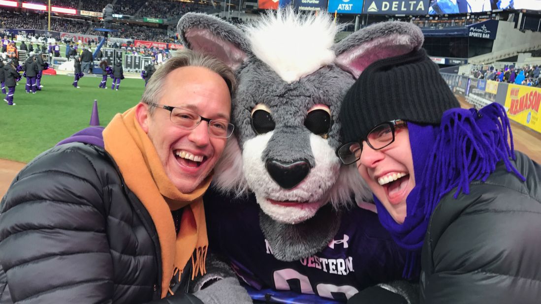 <strong>Purple pride</strong>: Peter Dangerfield and the author snag a pic with Northwestern mascot Willy the Wildcat at the 2016 Pinstripe Bowl, held in New York City's Yankee Stadium.