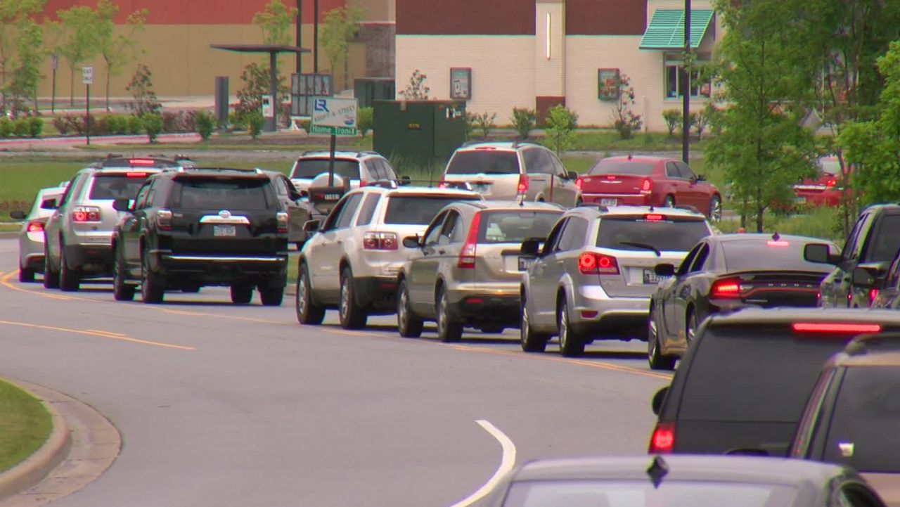 Cars line-up for free food from the Arkansas Foodbank at the Outlets of Little Rock on Tuesday, April 28.