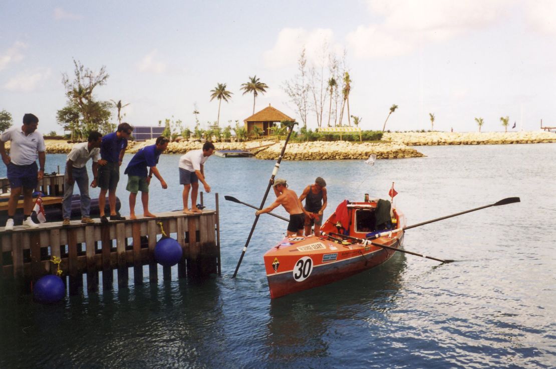 Graham Walters pushes off from a dock in his rowboat.