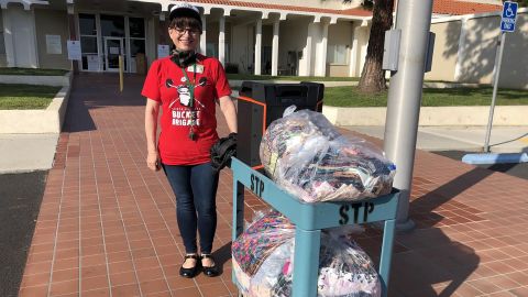 Deirdre Smith, program manager at Santa Barbara County Jail and former convict, collects mask to be sewn.