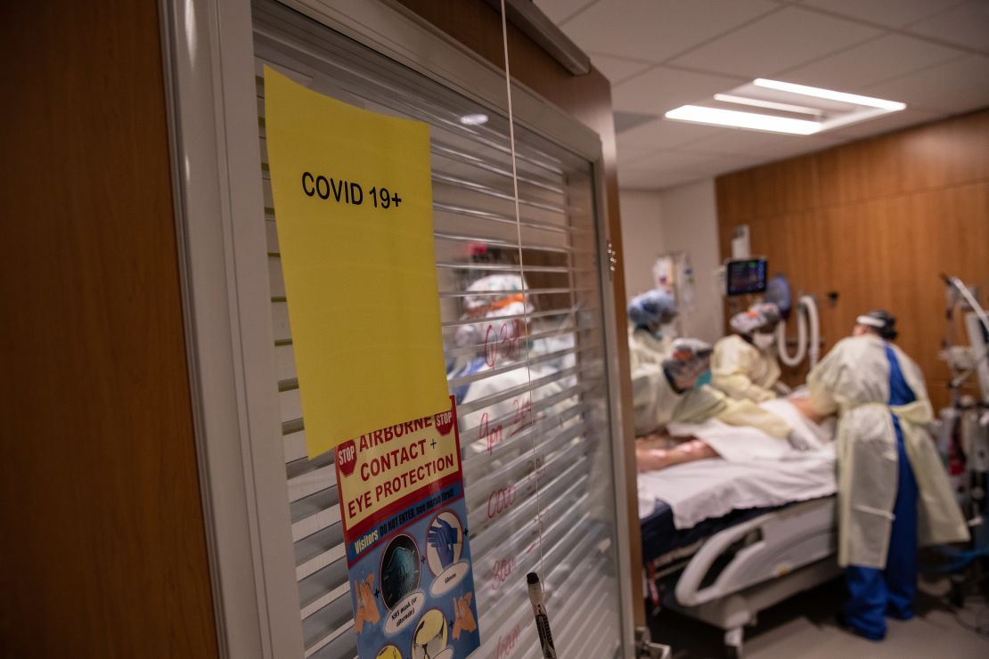 A "prone team," wearing personal protective equipment (PPE), prepares to turn a coronavirus patient onto his stomach.