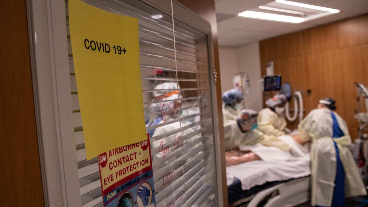 A "prone team," wearing personal protective equipment (PPE), prepares to turn a coronavirus patient onto his stomach.