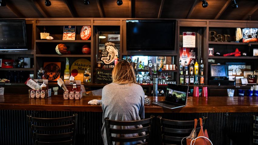 A customer sits at the bar of a BBQ restaurant amid the coronavirus pandemic in Atlanta, Georgia on April 27, 2020.
