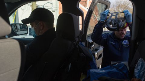 Incorvaia, in front seat, dons a surgical mask; Storzillo removes his respirator.