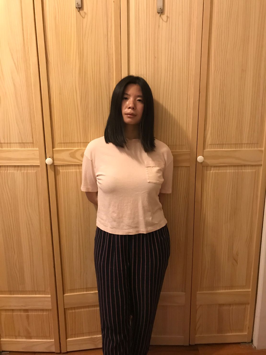 Lin Weng poses in her home in April. She applied for unemployment benefits after being furloughed from her job at a coffee shop. (Lin Weng)