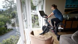 SAN ANSELMO, CALIFORNIA - APRIL 06:  Becky Friese Rodskog rides her Peloton exercise bike at her home on April 06, 2020 in San Anselmo, California.  More people are turning to Peloton due to shelter-in-place orders because of the coronavirus (COVID-19). The Peloton stock has continued to rise over recent weeks even as most of the stock market has plummeted. Peloton announced that they will temporarily pause all live classes until the end of April because an employee tested positive for coronavirus (COVID-19).  