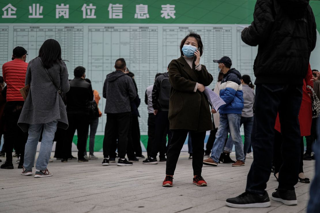 A job applicant makes a call at an on-site job fair in Wuhan last month. The landscape for job hunters might get even more difficult in the coming weeks as about 8.7 million people graduate from colleges and universities. 