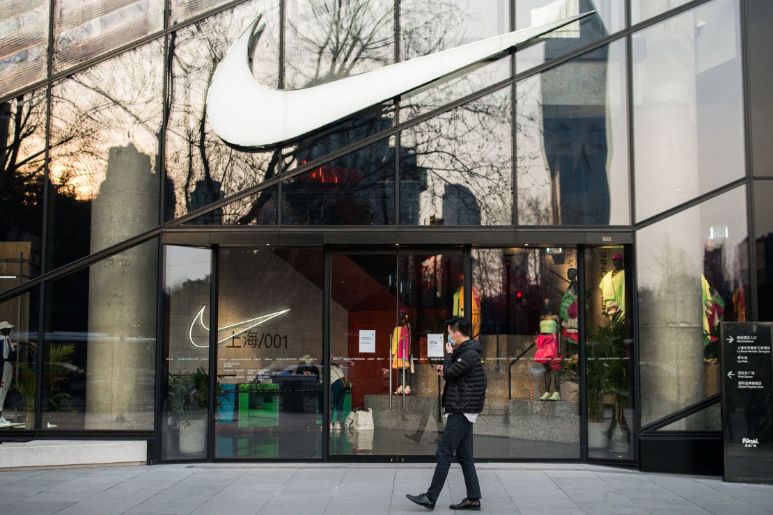 A pedestrian walking by a Nike store in Shanghai in March.