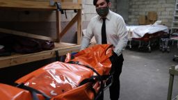 NEW YORK, NEW YORK - APRIL 29: The body of a coronavirus victim is transported to a refrigerated container at a funeral home in Queens on April 29, 2020 in New York City. The funeral home, which serves a busy and diverse community in Queens, has been overwhelmed with the deceased from COVID-19. Most of the employees of the funeral home are working seven days a week to serve multiple daily funerals and a continual arrival of the deceased. From grave diggers, to crematoriums to morgues, around New York City the funeral industry has been overwhelmed as COVID-19 continues to kill hundreds of New York residents daily. (Photo by Spencer Platt/Getty Images)