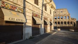 Closed stores selling ice cream, pasta and pizza lead to the Colosseum during coronavirus lockdown on Easter weekend in Rome, Italy, on Saturday, April 11, 2020.