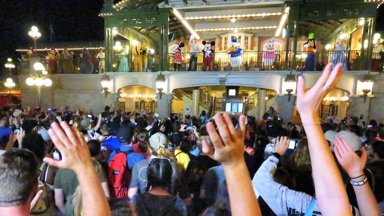 Guests wave goodbye to Mickey Mouse and friends on Main Street USA in the final minutes before the park closed March 15.